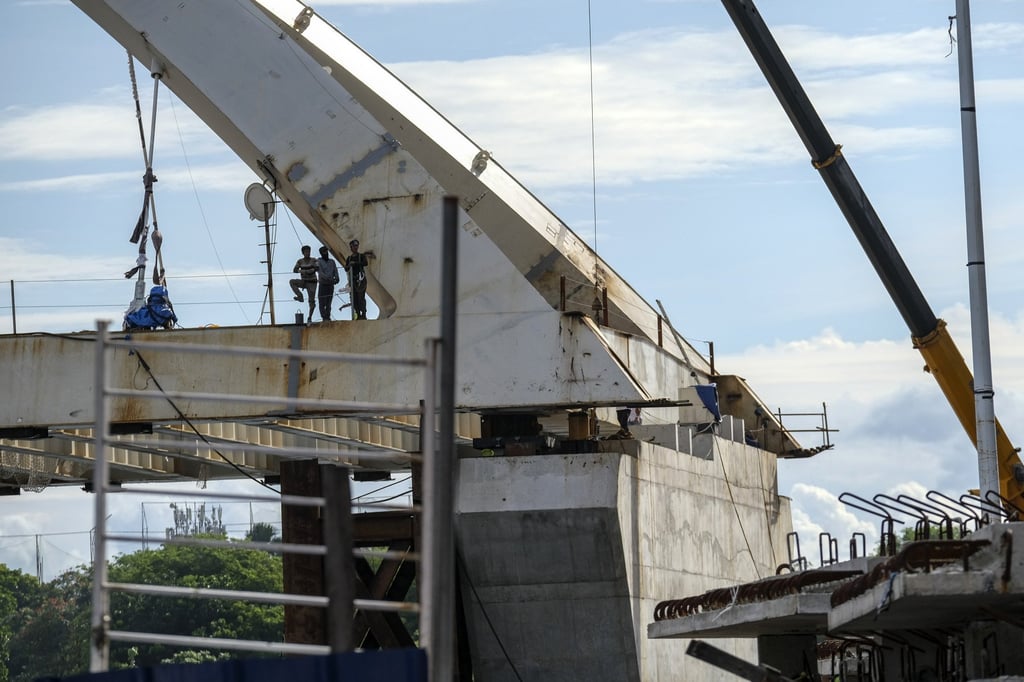 Construction workers look out from the Binondo-Intramuros Bridge, which connects the areas of Binondo, known as Chinatown, and Intramuros, in Manila, the Philippines, on June 22. This and other China-funded projects underpin Beijing’s role in Manila’s multi-year “Build, Build, Build” infrastructure programme. Photo: Bloomberg