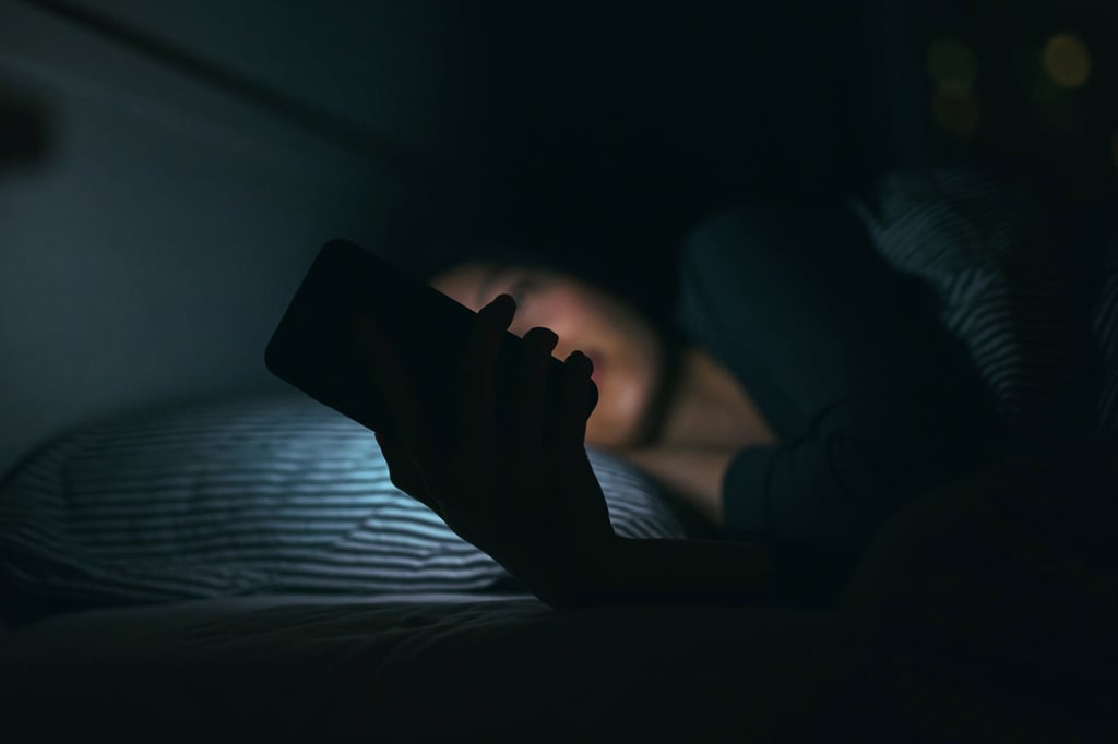 Keep blue light exposure to a minimum – switch off your devices two hours before bedtime. Photo: Getty Images