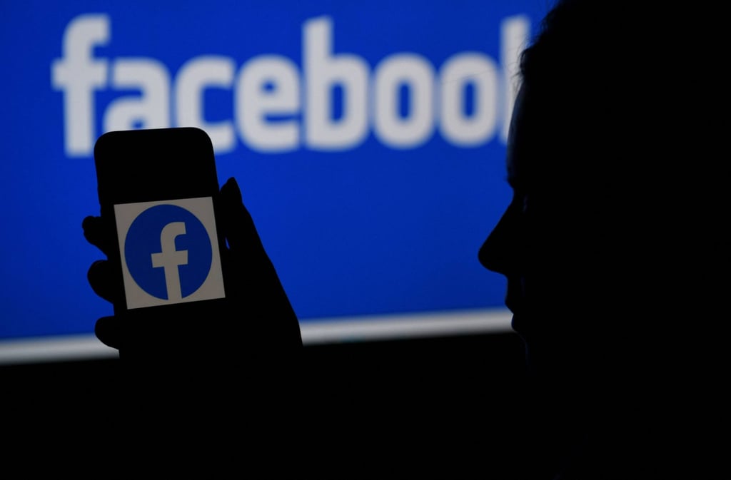 A smartphone screen displays the logo of Facebook on a Facebook website background in Arlington, Virginia, on June 16. Photo: AFP