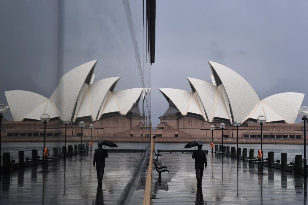 A pedestrian near the Sydney Opera House in Sydney, New South Wales, Australia. Delta-fuelled outbreaks in Australia’s New South Wales and Victoria have shattered the country’s Covid-free image. Photo: EPA