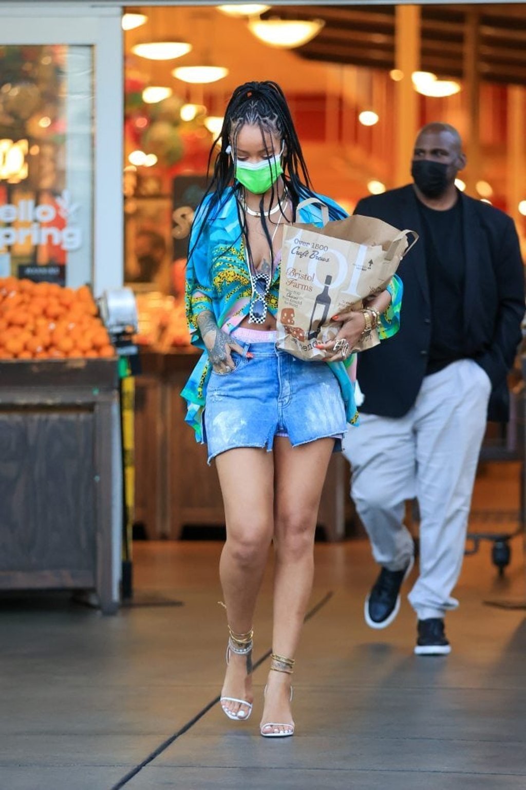 Rihanna was recently snapped carrying a brown paper bag of groceries while wearing a silk shirt, denim shorts and heels. Photo: GC Images
