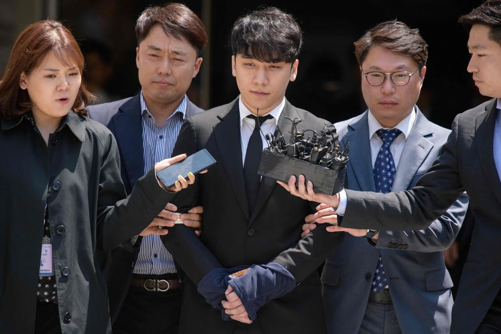 Seungri (centre) is taken into custody as he leaves the High Court in Seoul, South Korea. Photo: AFP Seungri (centre) is taken into custody as he leaves the High Court in Seoul, South Korea. Photo: AFP