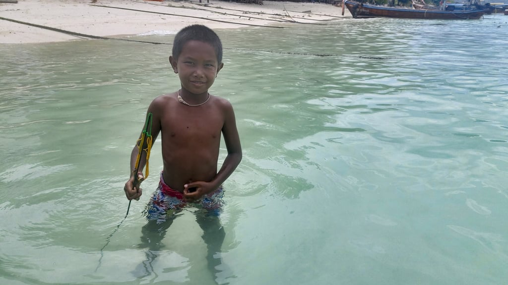 Kiang’s son holds a spear gun, used for fishing. Photo: Philipp Meier Kiang’s son holds a spear gun, used for fishing. Photo: Philipp Meier