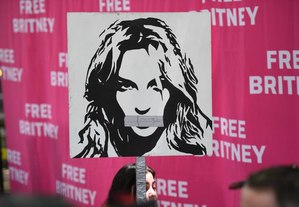 A woman holds a poster of Britney Spears with her mouth taped shut as fans and supporters gather outside the Los Angeles County Courthouse in Los Angeles during a scheduled hearing in the Spears guardianship case on July 14. Photo: AFP A woman holds a poster of Britney Spears with her mouth taped shut as fans and supporters gather outside the Los Angeles County Courthouse in Los Angeles during a scheduled hearing in the Spears guardianship case on July 14. Photo: AFP