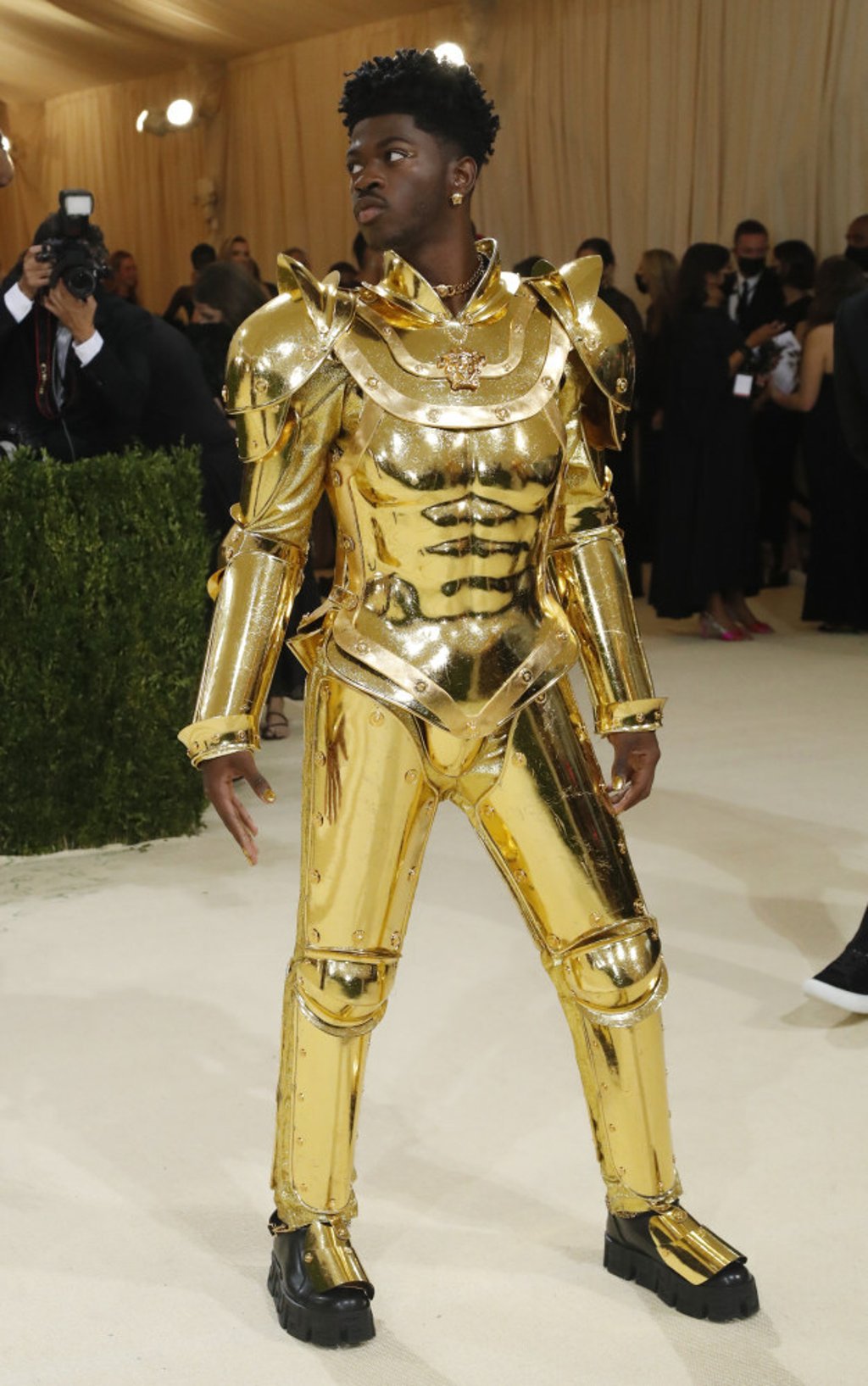Lil Nas X wore a gold suit of armour that he took off to reveal a crystal-inspired bodysuit from Versace. Photo: Reuters