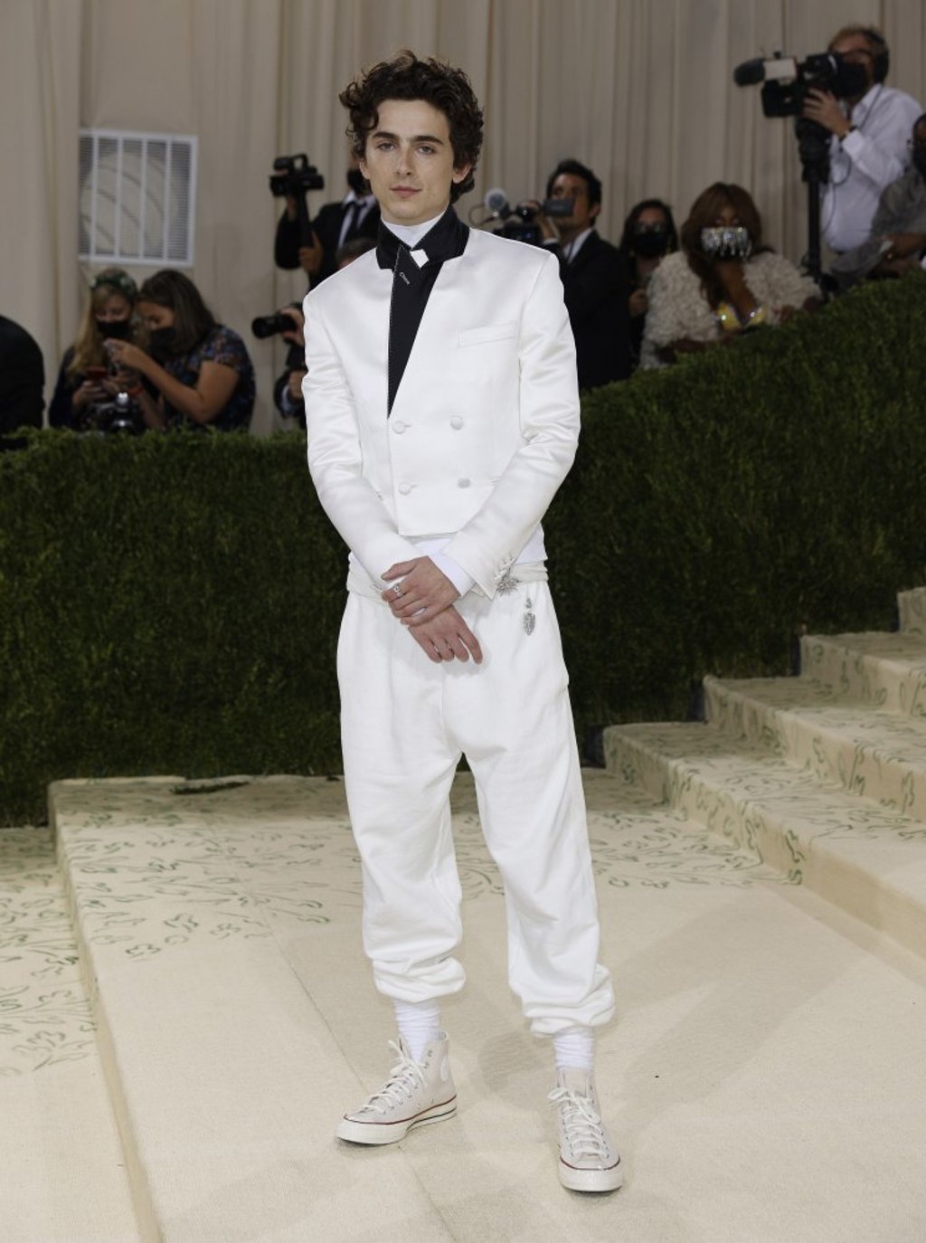 Timothée Chalamet sported a white silk suit with black lapels and white high-top sneakers from Haider Ackermann. Photo: EPA