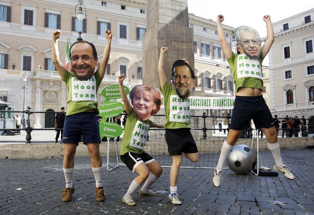 Masked demonstrators in June 2012 depicting (from left) then French president Francois Hollande, German Chancellor Angela Merkel, Spanish prime minister Mariano Rajoy and Italian prime minister Mario Monti simulate playing a soccer match to protest against the euro-zone debt crisis, in front of the Chigi Palace in Rome. Photo: Reuters Masked demonstrators in June 2012 depicting (from left) then French president Francois Hollande, German Chancellor Angela Merkel, Spanish prime minister Mariano Rajoy and Italian prime minister Mario Monti simulate playing a soccer match to protest against the euro-zone debt crisis, in front of the Chigi Palace in Rome. Photo: Reuters