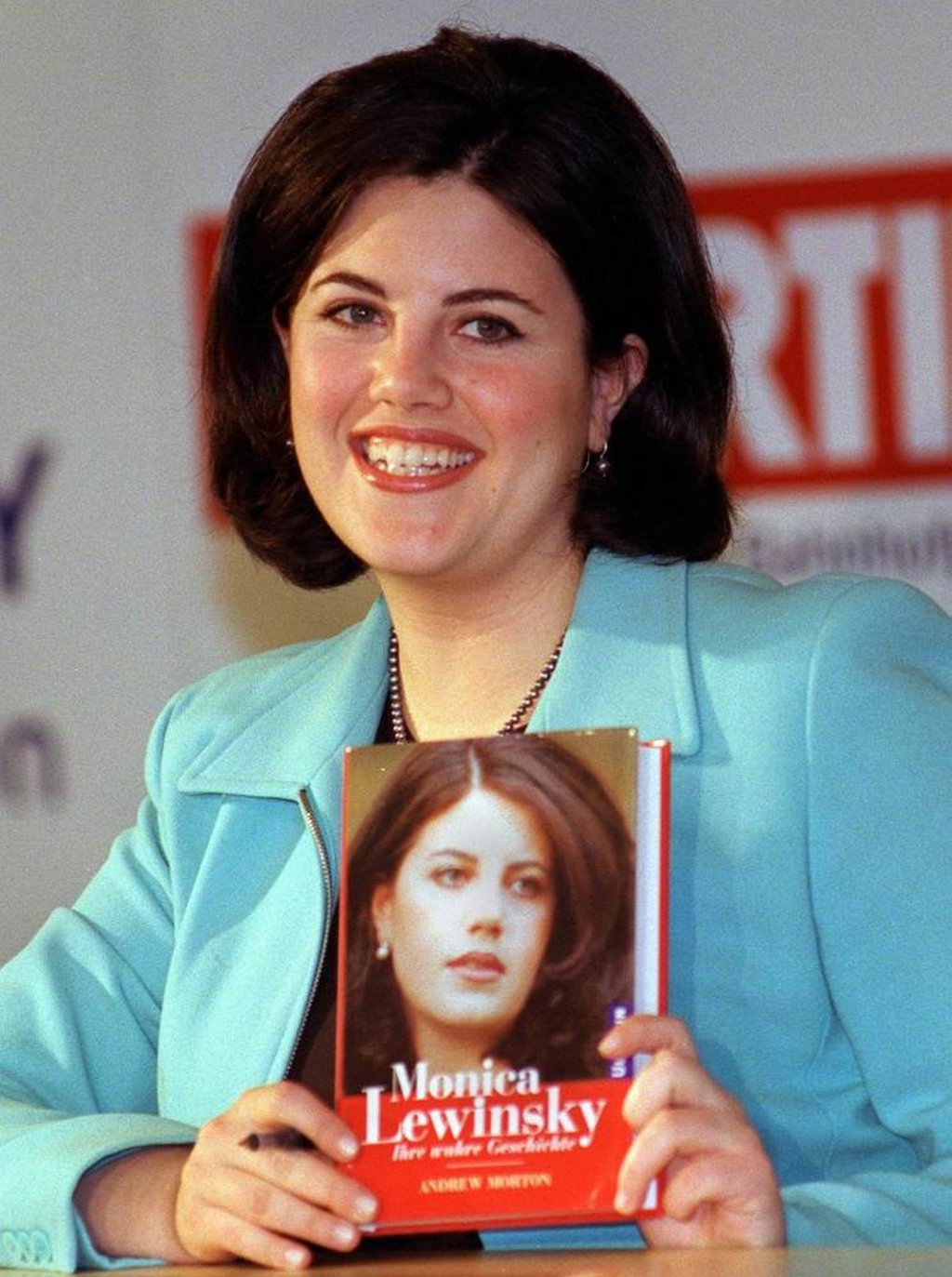 Monica Lewinsky holds up a copy of her book during a book-signing session at a Munich department store in March 1999. Photo: AFP Monica Lewinsky holds up a copy of her book during a book-signing session at a Munich department store in March 1999. Photo: AFP