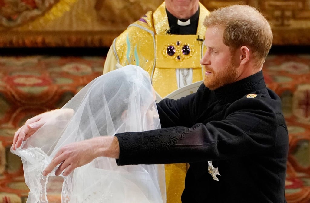 Britain’s Prince Harry, Duke of Sussex, removes the veil of US actress Meghan Markle as they stand at the altar together before Archbishop of Canterbury Justin Welby in St. George’s Chapel, Windsor Castle, in Windsor, in May 2018 during their wedding ceremony. Photo: AFP Photo