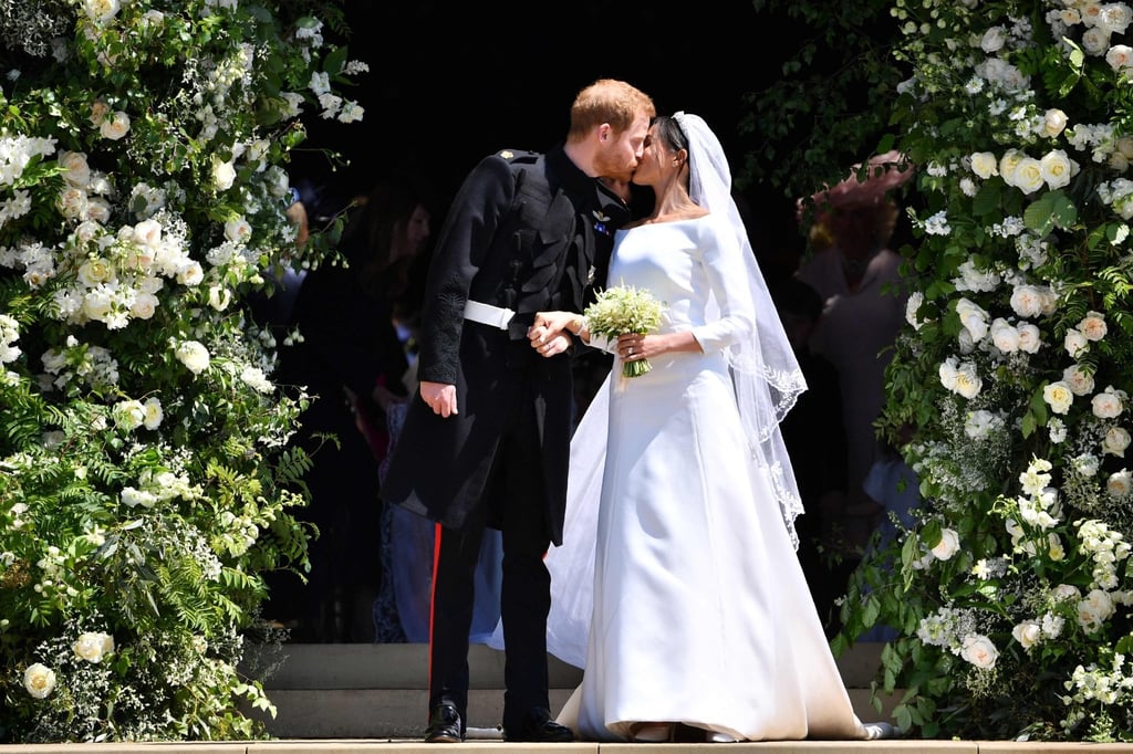 Britain’s Prince Harry, Duke of Sussex, kisses his wife Meghan, Duchess of Sussex, as they leave from the West Door of St. George’s Chapel, Windsor Castle, in Windsor, in May 2018 after their wedding ceremony. Photo: AFP
