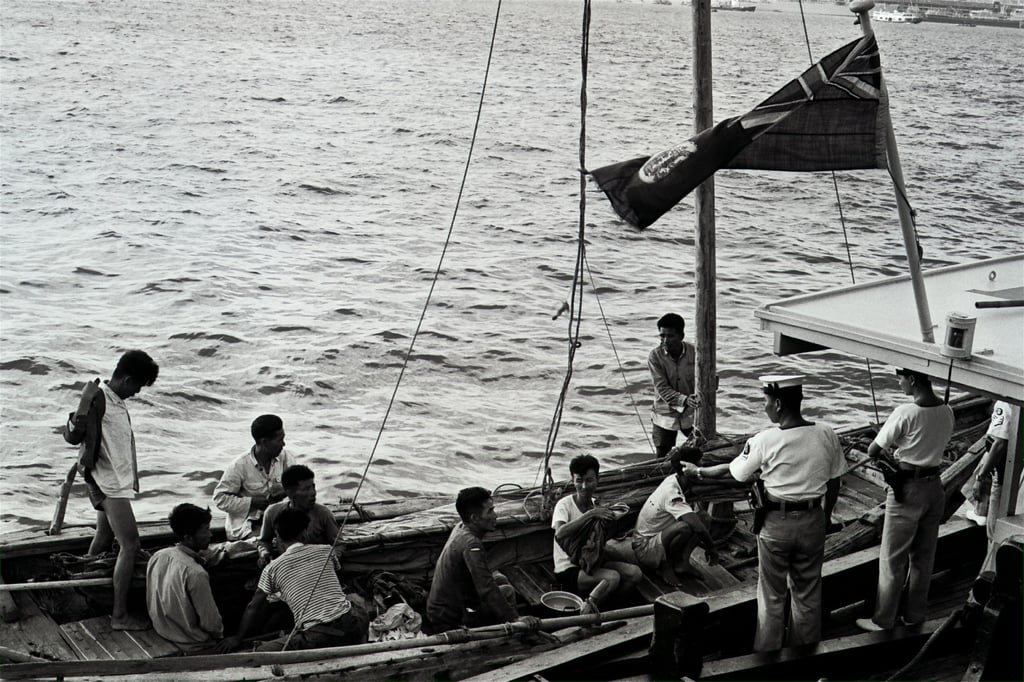 Refugees from China prepare to disembark from their junk under the supervision of Hong Kong marine police officers in 1968. People who had fled vicious political campaigns sought a peaceful life in the then British colony. Photo: SCMP Refugees from China prepare to disembark from their junk under the supervision of Hong Kong marine police officers in 1968. People who had fled vicious political campaigns sought a peaceful life in the then British colony. Photo: SCMP