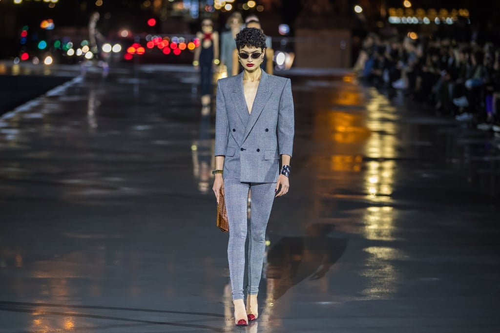 A model presents a creation from the spring/summer 2022 ready-to-wear collection by Saint Laurent fashion house in front of the Eiffel Tower during Paris Fashion Week, in Paris, France, 28 September 2021. Photo: EPA-EFE A model presents a creation from the spring/summer 2022 ready-to-wear collection by Saint Laurent fashion house in front of the Eiffel Tower during Paris Fashion Week, in Paris, France, 28 September 2021. Photo: EPA-EFE