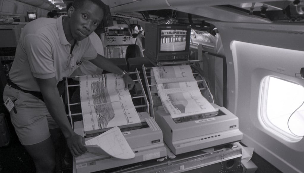 A Nasa scientist at work on board the specially fitted DC-8 plane to measure greenhouse gases over the Pacific.