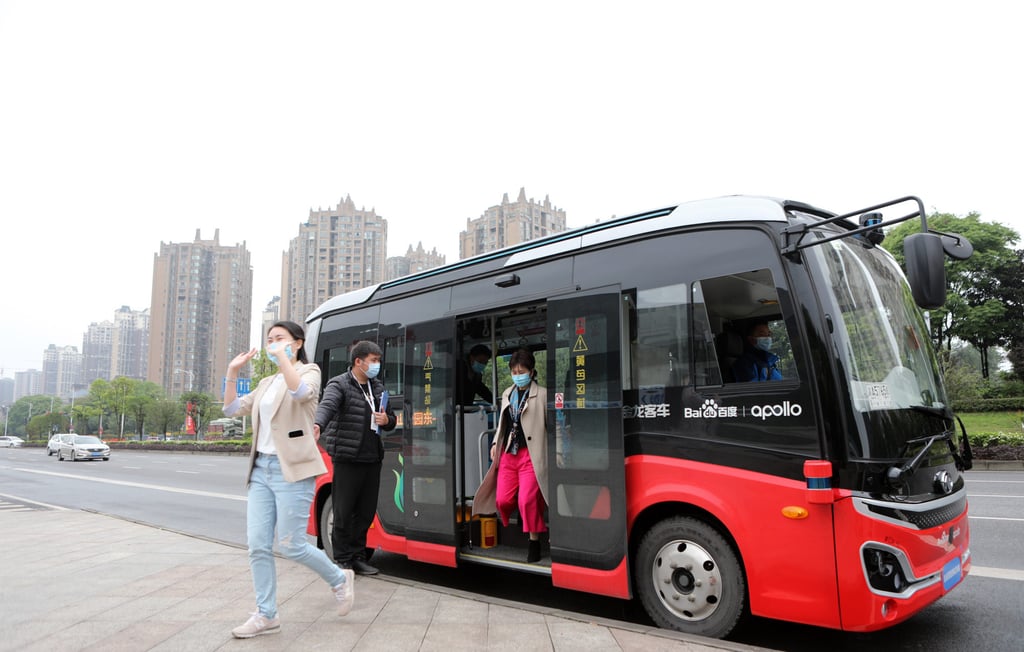 Passengers get off an autonomous bus developed by Chinese tech giant Baidu in Chongqing, where China’s first autonomous bus line started commercial operations in April, 2021. Photo Chen Shichuan/VCG via Getty Images