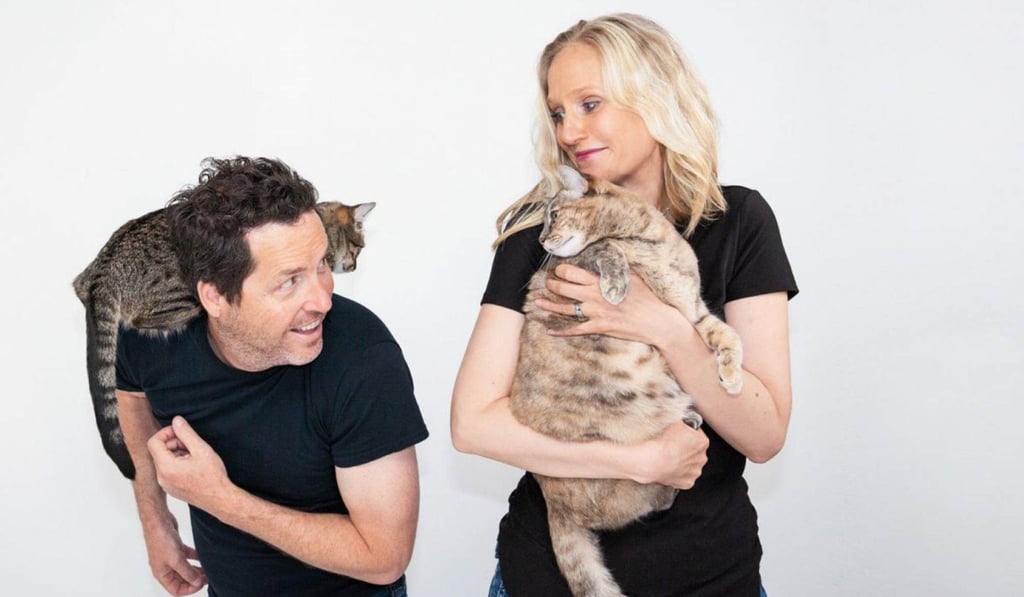Fred and Natasha Ruckel with their cats Spock and Yoda. Fred is the co-owner and inventor of the Ripple Rug. Photo: Ripple Rug