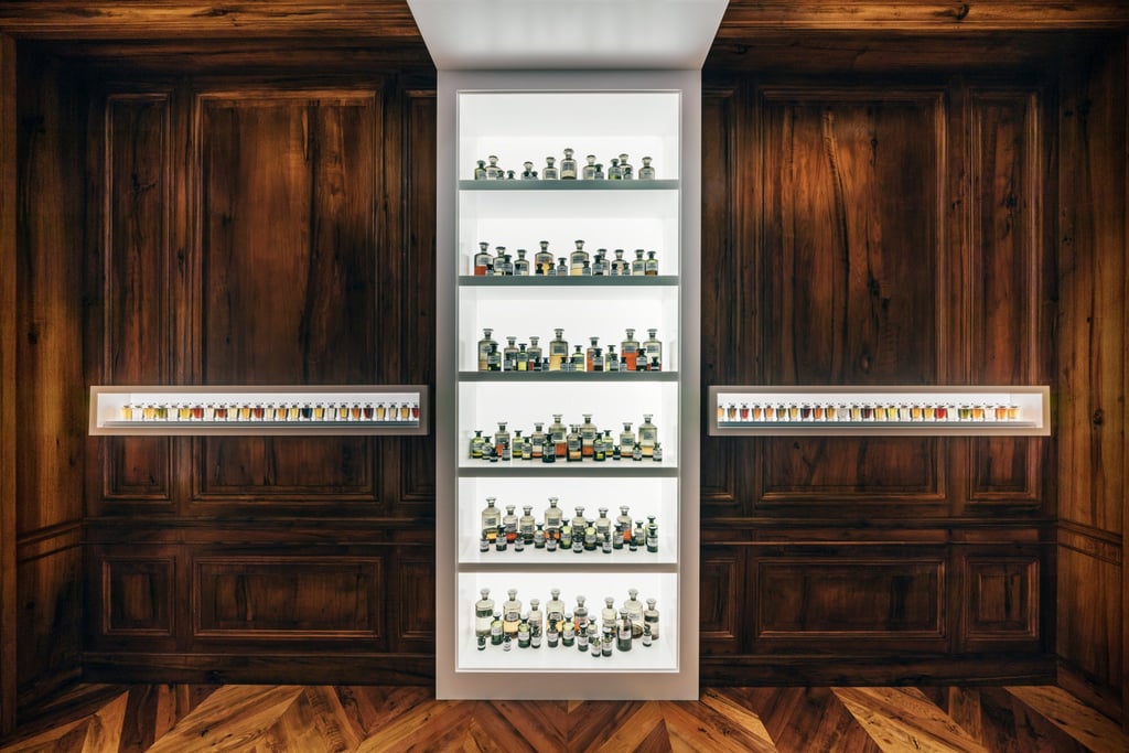 A wall of flasks, beakers and containers of essences, set between shelves of perfume bottles, greets visitors to the new Henry Jacques boutique.