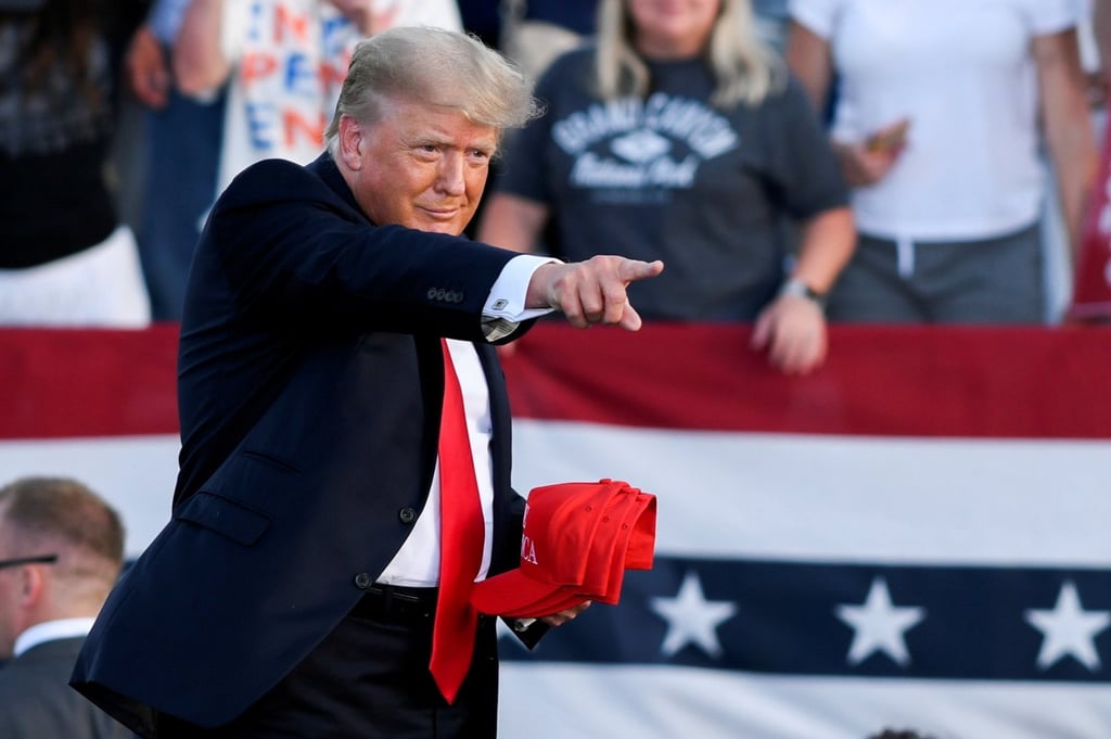 Former US president Donald Trump holds MAGA hats during his first post-presidency campaign rally at the Lorain County Fairgrounds in Wellington, Ohio, US, in June 2021. Photo: Reuters