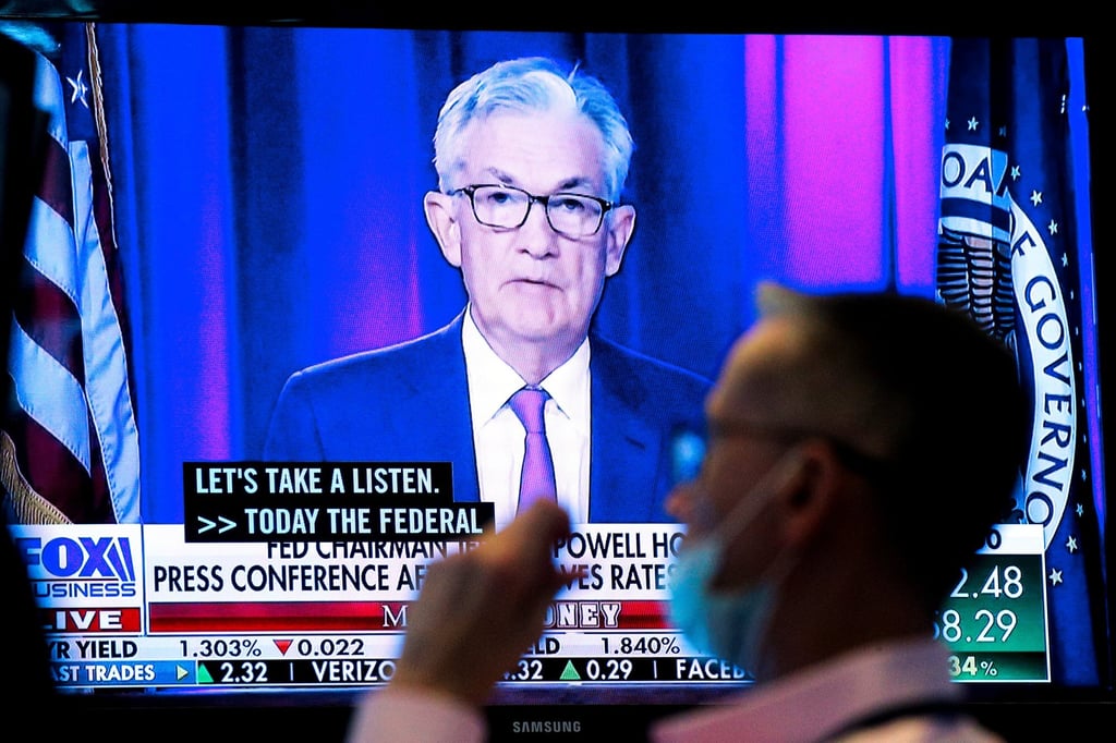 A screen displays a statement by US Federal Reserve chair Jerome Powell as a trader works at the New York Stock Exchange on September 22. Photo: Reuters