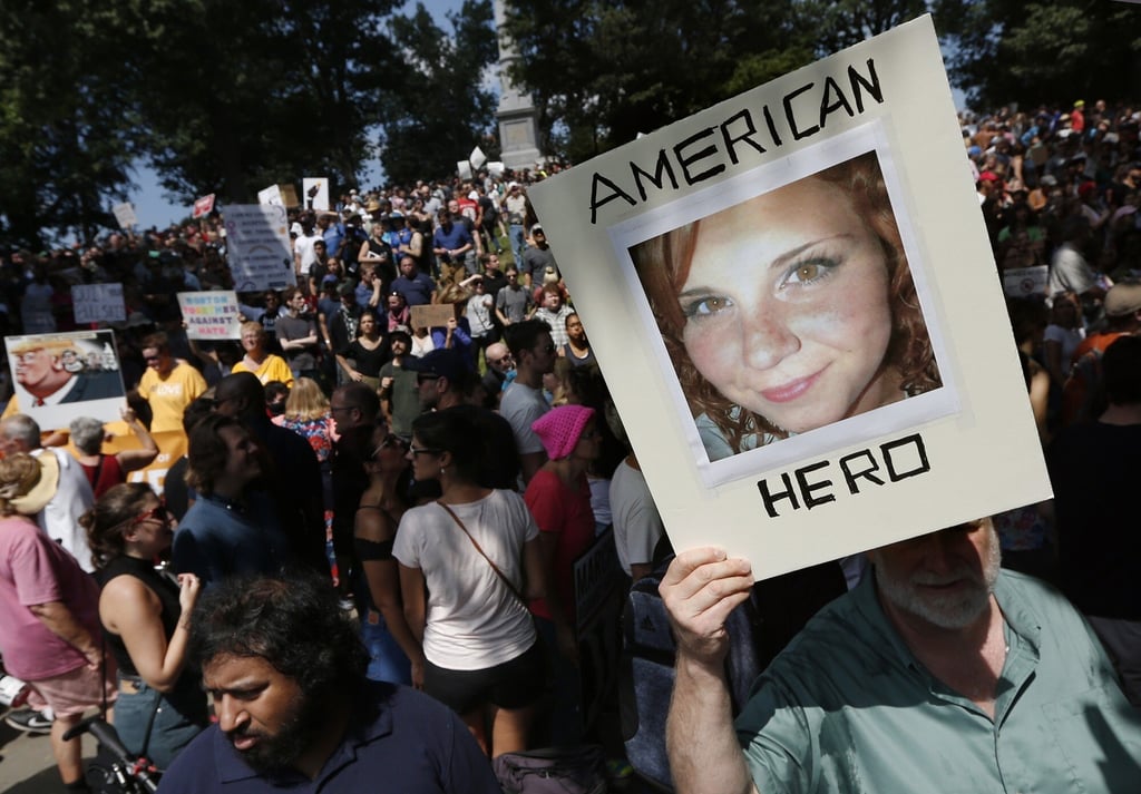 A counterprotester holds a photo of Heather Heyer at a “Free Speech” rally organised by conservative activists in Boston in August 2017. Photo: AP