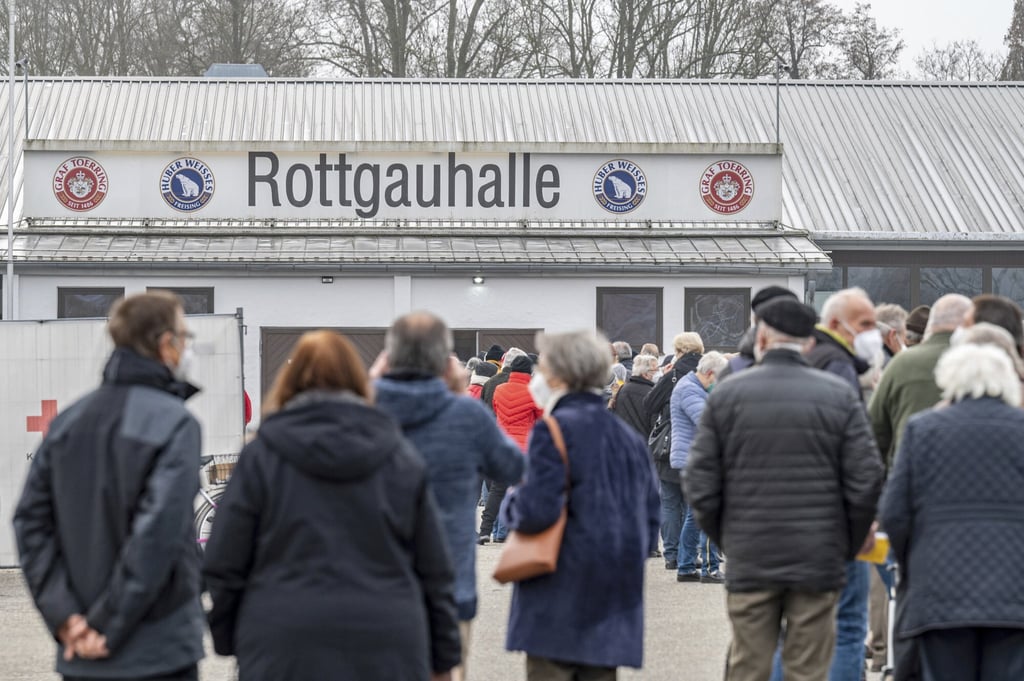 People stand in line at a Covid-19 vaccination centre in Eggenfelden, Germany. Photo: Armin Weigel/dpa via AP