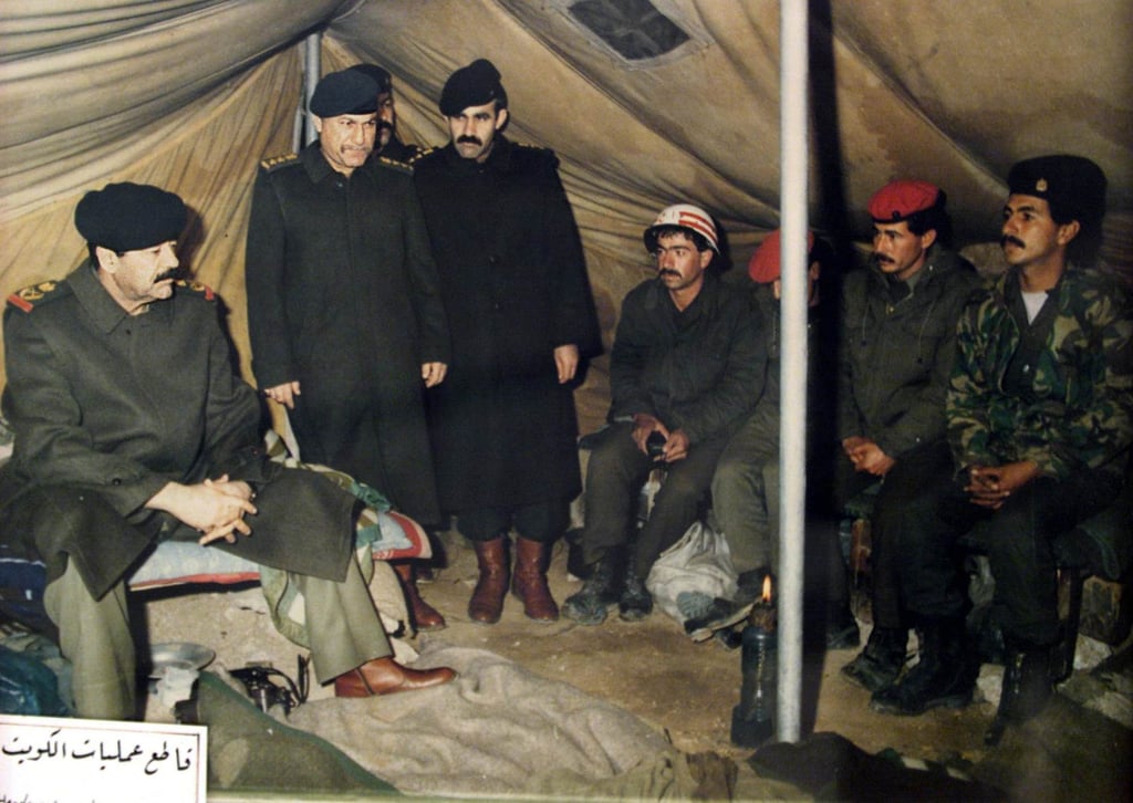 A reproduction of a picture displayed at the Nasr or Victory Museum in Baghdad shows Iraqi President Saddam Hussein (left) visiting troops at a military camp in occupied territory in Kuwait after the August 2, 1990 invasion. Photo: AFP A reproduction of a picture displayed at the Nasr or Victory Museum in Baghdad shows Iraqi President Saddam Hussein (left) visiting troops at a military camp in occupied territory in Kuwait after the August 2, 1990 invasion. Photo: AFP