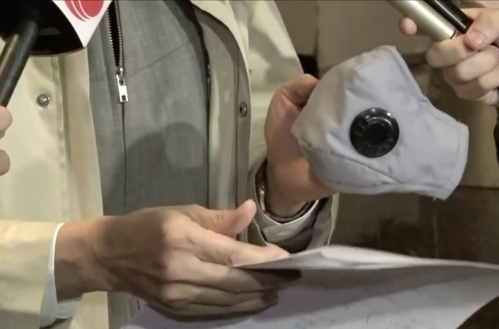 Professor Yuen Kwok-yung holds a mask with air valves, like the one worn by the arrival from South Africa. The valves, which cause the mask to block incoming air but allow potentially infectious exhaled air to leave, have been described as ‘selfish’. Photo: RTHK Professor Yuen Kwok-yung holds a mask with air valves, like the one worn by the arrival from South Africa. The valves, which cause the mask to block incoming air but allow potentially infectious exhaled air to leave, have been described as ‘selfish’. Photo: RTHK