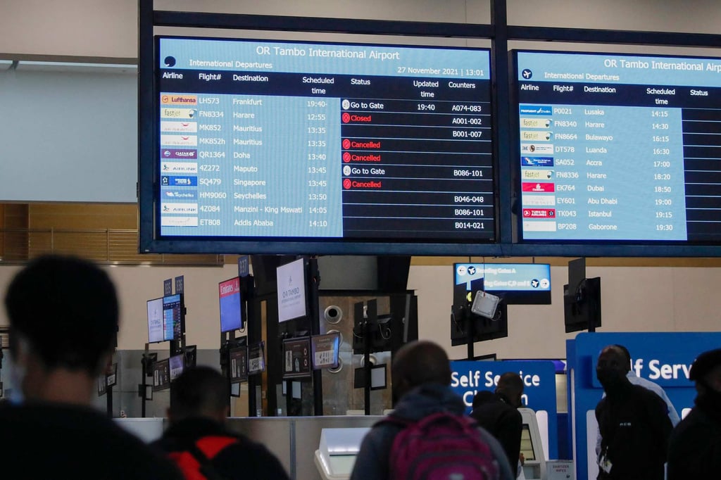 Travellers walk near an electronic flight notice board displaying cancelled flights at OR Tambo International Airport in Johannesburg on November 27 after several countries banned flights from South Africa following the discovery of a new Covid-19 variant, Omicron. Photo: AFP Travellers walk near an electronic flight notice board displaying cancelled flights at OR Tambo International Airport in Johannesburg on November 27 after several countries banned flights from South Africa following the discovery of a new Covid-19 variant, Omicron. Photo: AFP
