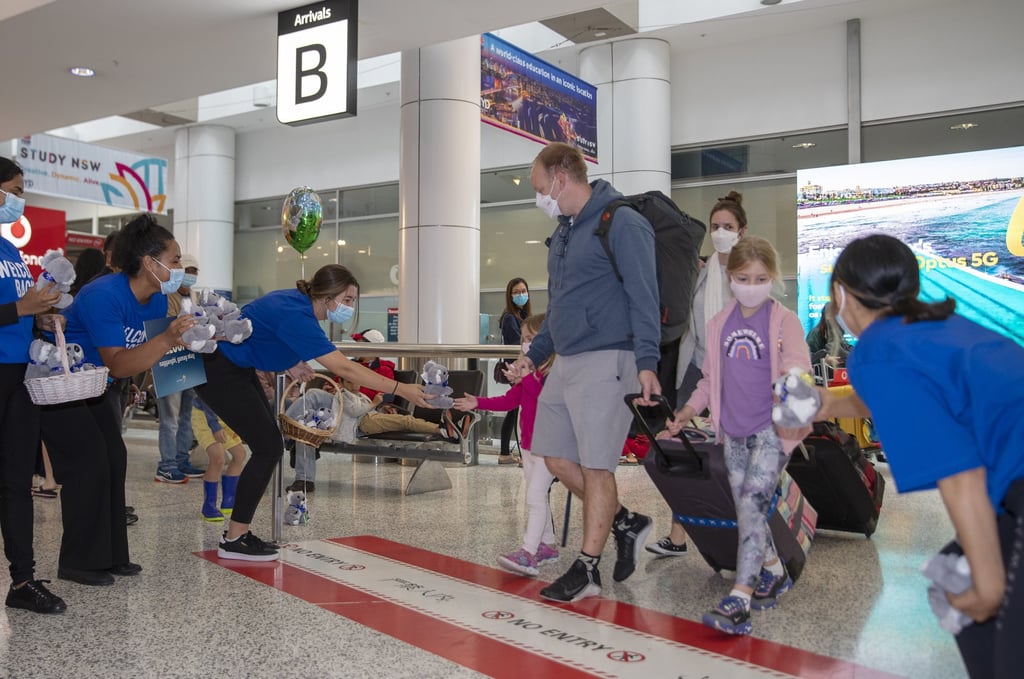 Airport employees welcome travellers on their arrival at Sydney Airport earlier this month. Photo: Xinhua