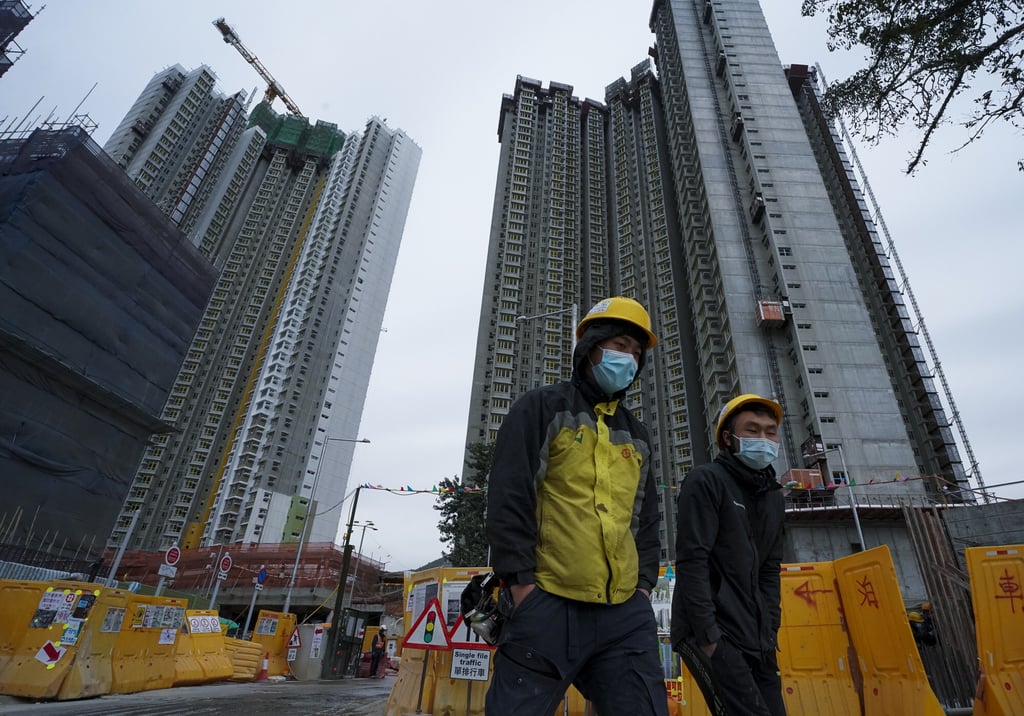 Two workers leave the public housing project Queen’s Hill House in Fanling. Photo: Felix Wong