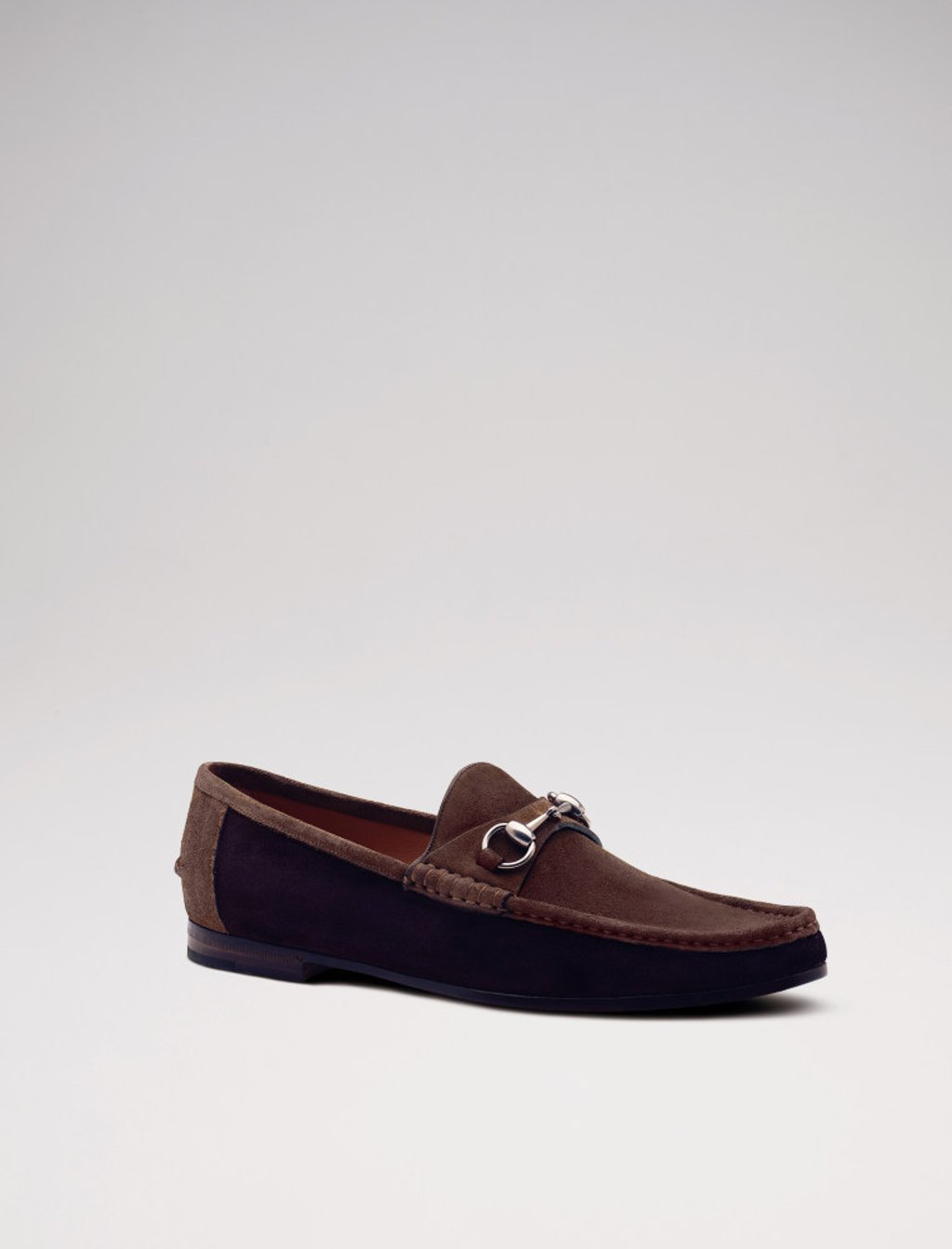 Slip on this pair of suede, two-toned loafers with a horsebit embellishment from Gucci. Photo: Handout