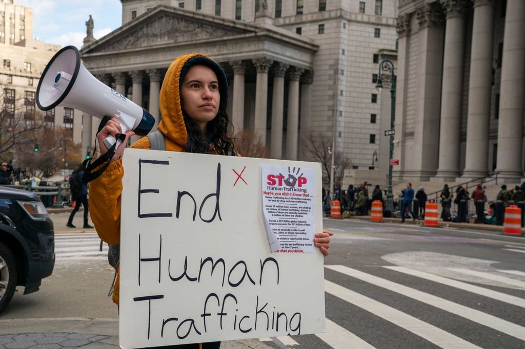 A protester against human trafficking on Monday, outside the courthouse in New York where the trial of Ghislaine Maxwell is being held. Photo: AFP