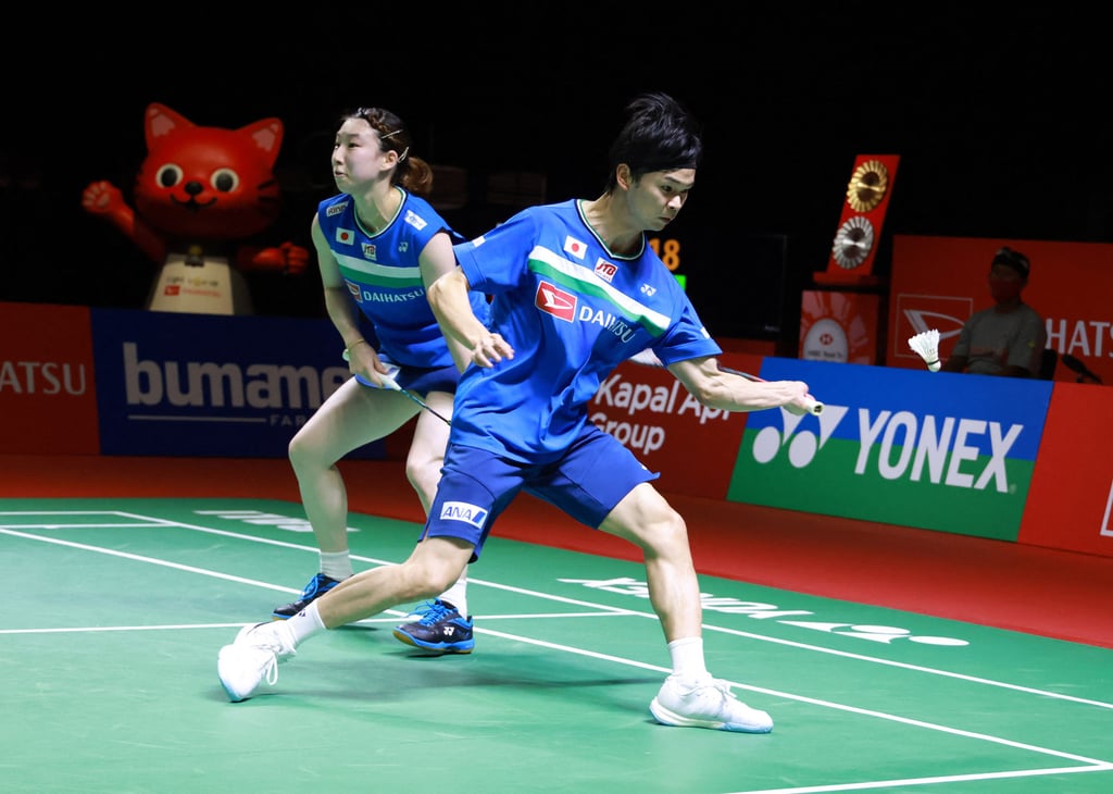 Yuta Watanabe (right) and Arisa Higashino, of Japan, competing against Hong Kong’s Tang Chun-man and Tse Ying-suet during their mixed doubles semi-final badminton match at the Indonesia Masters. Photo: AFP / Badminton Association of Indonesia.
