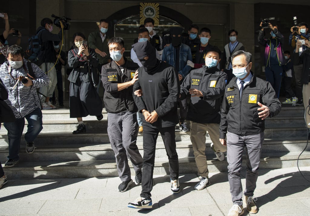 Macau police on Saturday arrest one of the 11 suspects accused of belonging to a cross-border gambling and money laundering syndicate. Photo: Xinhua