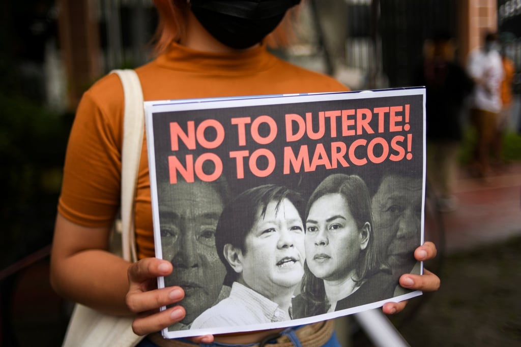 An activist holds a placard at a protest against Marcos Jnr and Duterte-Carpio in Quezon City, Metro Manila, earlier this year. Photo: Reuters An activist holds a placard at a protest against Marcos Jnr and Duterte-Carpio in Quezon City, Metro Manila, earlier this year. Photo: Reuters