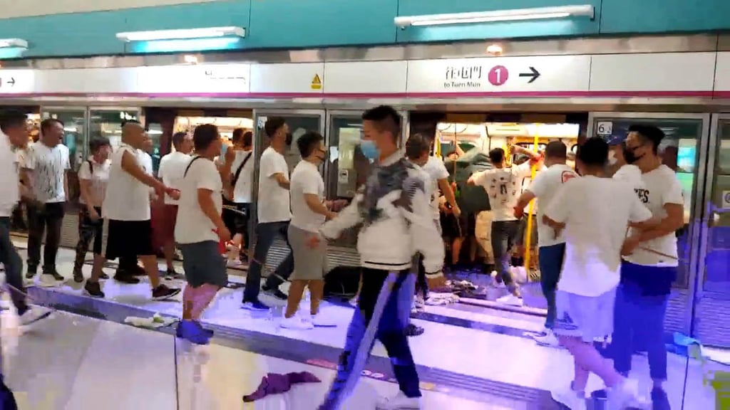 Men dressed in white T-shirts attack protesters and commuters at the Yuen Long MTR station on July 21, 2019. Photo: Handout Men dressed in white T-shirts attack protesters and commuters at the Yuen Long MTR station on July 21, 2019. Photo: Handout