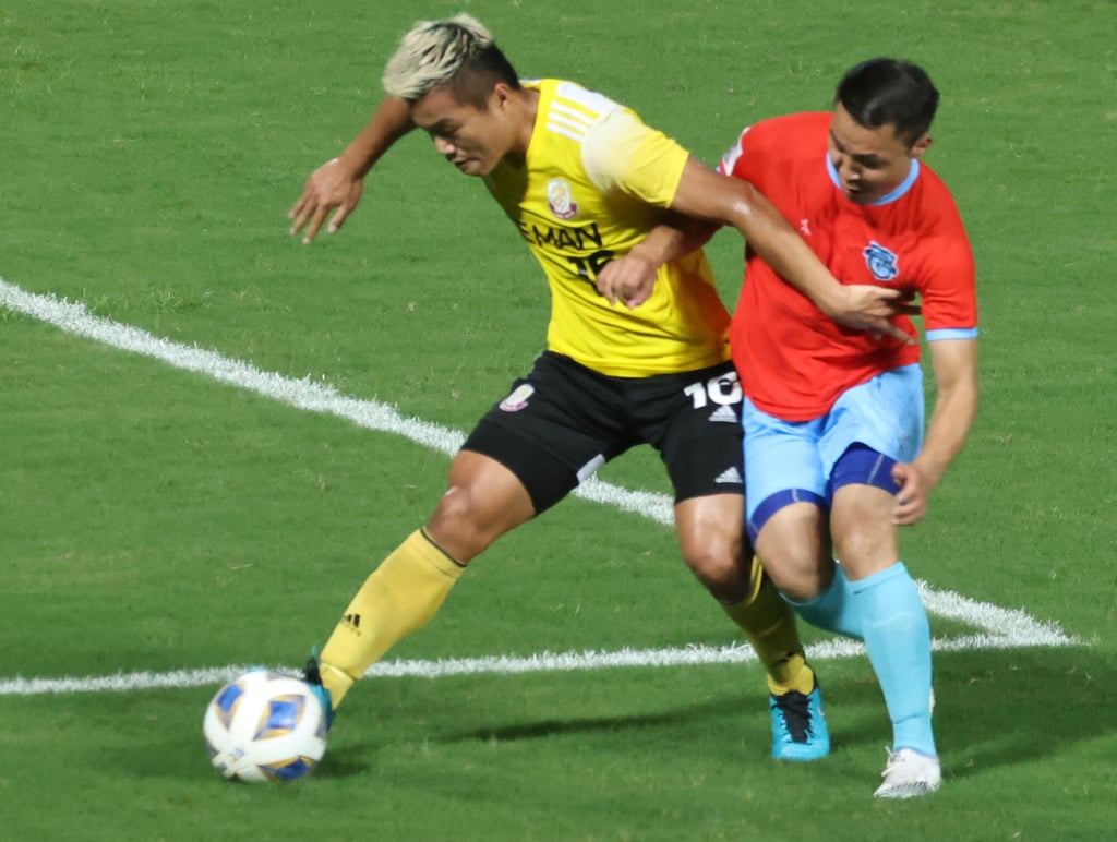 Lee Man’s Ngan Lok-fung (yellow) in action with Athlect 220 FC’s Enkhbileg Purevdorj during the AFC Cup 2021 Group J match between Athletic 220 FC and Lee Man at Tseung Kwan O Sports Ground. Photo: SCMP / K. Y. Cheng