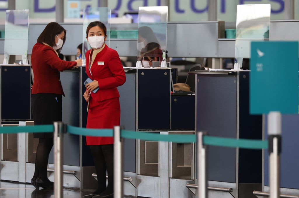 Cathay staff at the airport. The airline has come under increasing pressure from changing travel rules amid the pandemic. Photo: Dickson Lee