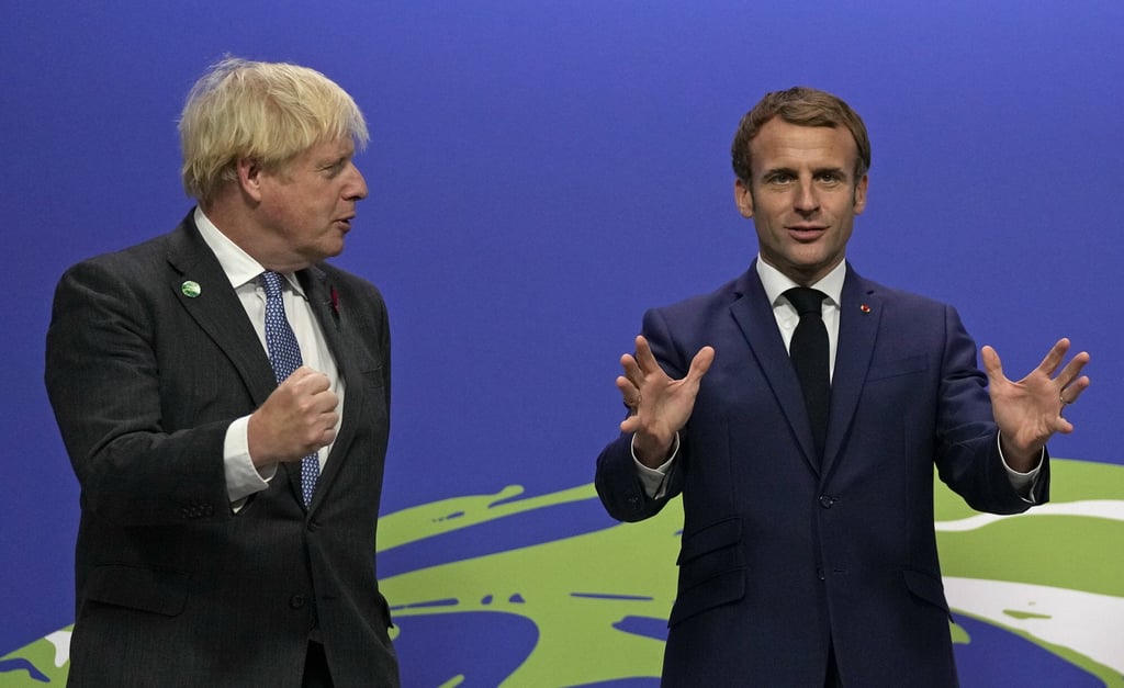 British Prime Minister Boris Johnson (left) greets French President Emmanuel Macron as he arrives at the COP26 climate summit in Glasgow on November 1. Photo: AP