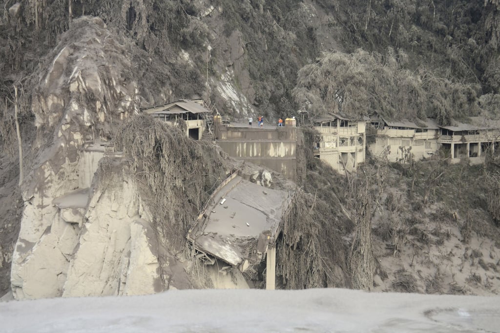 Remains of a bridge is seen in a slope, destroyed by the flowing lava from Mount Semeru. Photo: AP Remains of a bridge is seen in a slope, destroyed by the flowing lava from Mount Semeru. Photo: AP