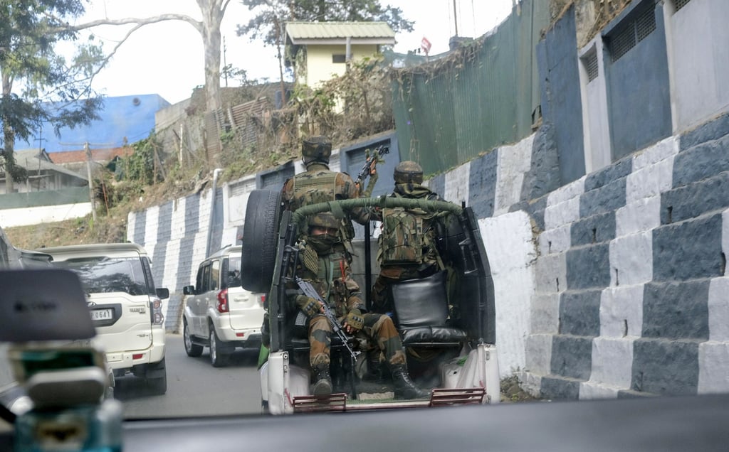 Indian army soldiers ride in a convoy through Kohima, capital of northeastern Nagaland state, after protests by villagers. Photo: AP Indian army soldiers ride in a convoy through Kohima, capital of northeastern Nagaland state, after protests by villagers. Photo: AP