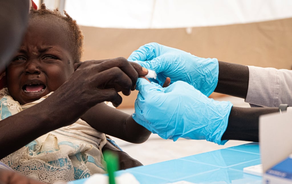 A child reacts as she is screened for the malaria disease in South Sudan. Photo: Medecins Sans Frontieres/Handout via Reuters