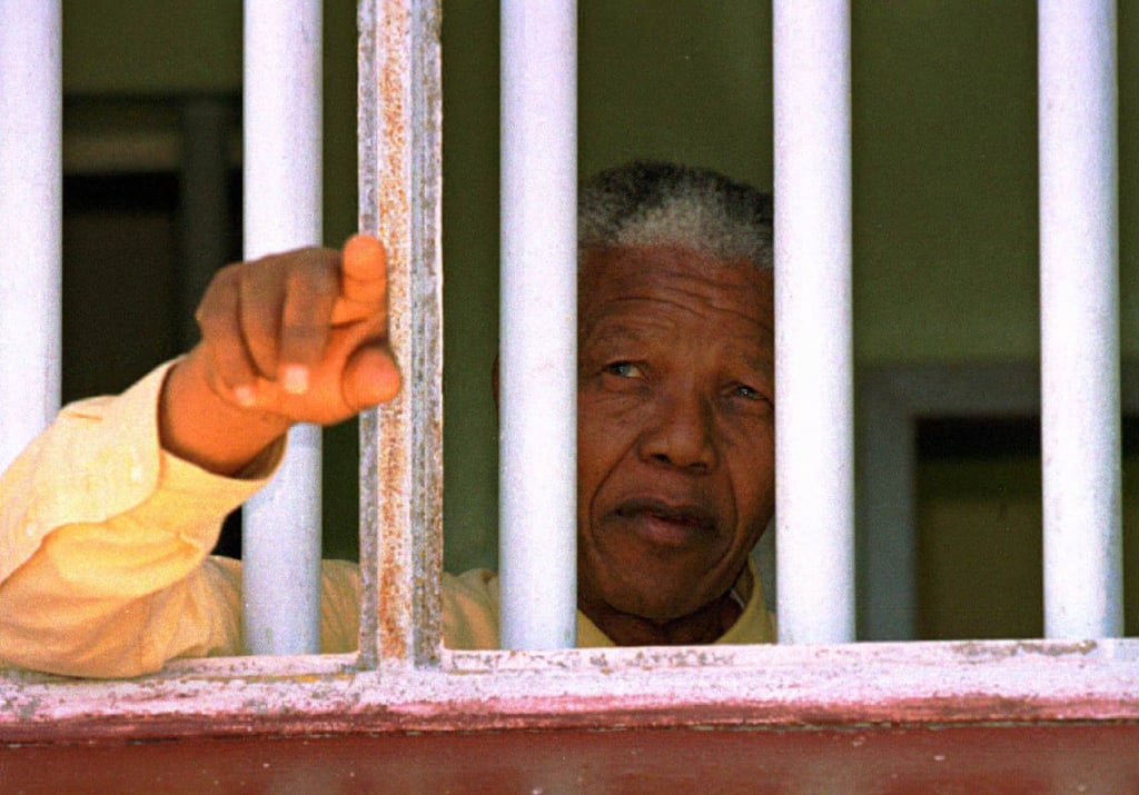 Nelson Mandela looks out of the window of the prison cell he occupied on Robben Island in this 1996 file photo. Photo: Reuters Nelson Mandela looks out of the window of the prison cell he occupied on Robben Island in this 1996 file photo. Photo: Reuters
