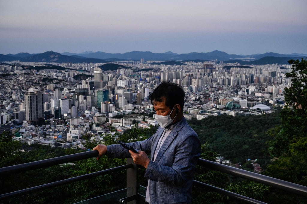 A man uses his phone as he stands on an observation deck beneath the YTN Seoul Tower with a view of residential and commercial buildings on September 3. Last quarter, prime residential prices in South Korea’s capital rose 22.6 per cent year on year. Photo: AFP A man uses his phone as he stands on an observation deck beneath the YTN Seoul Tower with a view of residential and commercial buildings on September 3. Last quarter, prime residential prices in South Korea’s capital rose 22.6 per cent year on year. Photo: AFP