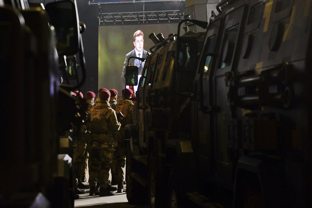 Ukrainian servicemen watch as President Volodymyr Zelensky speaks during a parade marking the Day of the Armed Forces of Ukraine on Monday. Photo: AP