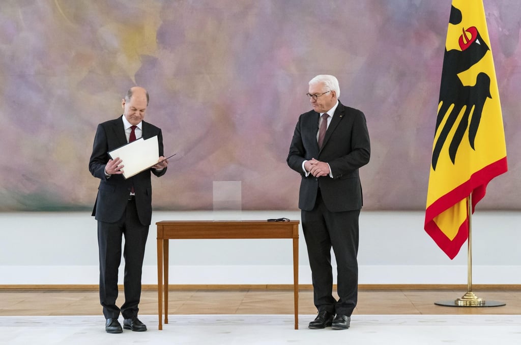 New elected German Chancellor Olaf Scholz, left, holds his letter of appointment presented by German President Frank-Walter Steinmeier. Photo:AP