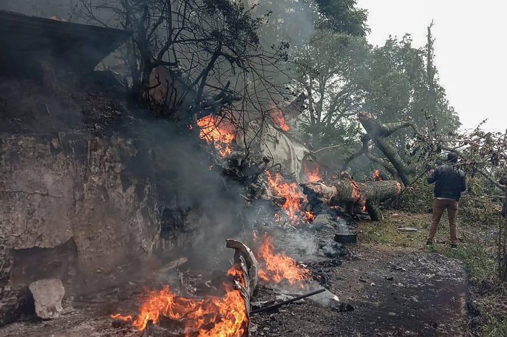 Burning debris is seen at the crash site in Coonoor, Tamil Nadu, on December 8, 2021. Photo: AFP