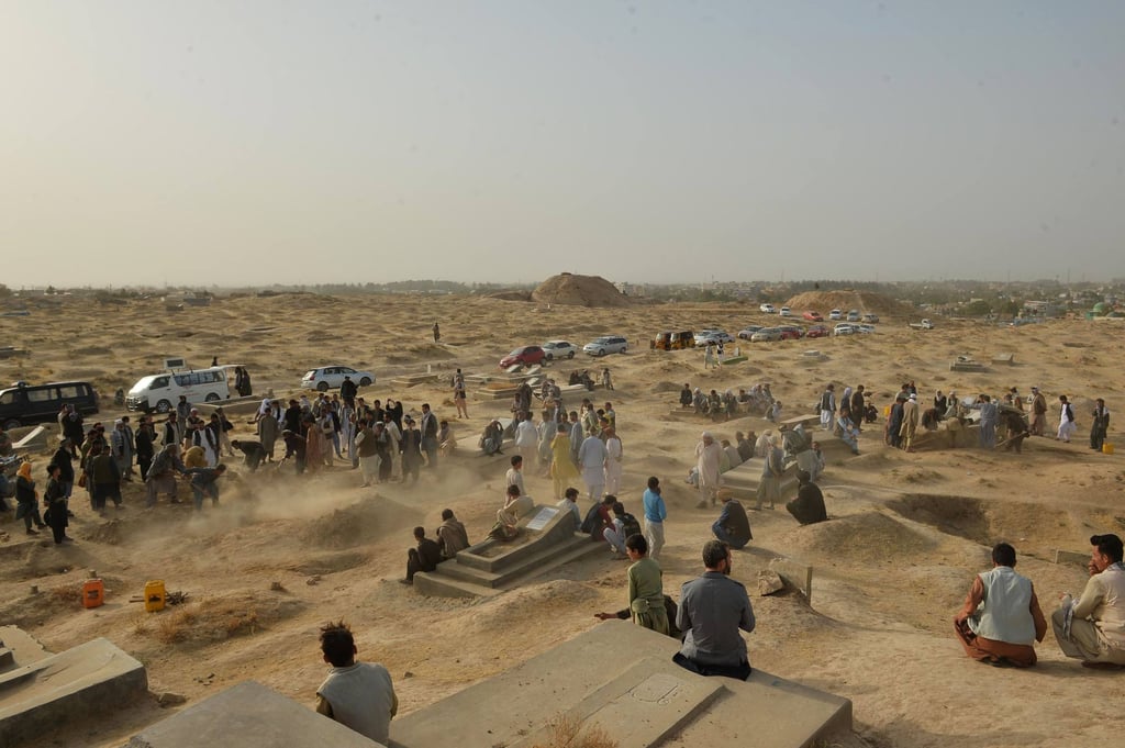 Relatives and friends stand next to graves of victims of a suicide bomb attack on worshippers at a Shiite mosque, in which at least 55 people died, in Kunduz, Afghanistan in October 2021. Photo: AFP Relatives and friends stand next to graves of victims of a suicide bomb attack on worshippers at a Shiite mosque, in which at least 55 people died, in Kunduz, Afghanistan in October 2021. Photo: AFP