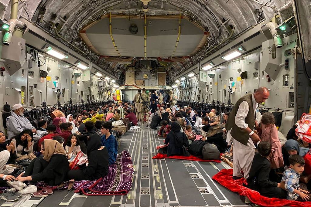 Afghan people sitting inside a US military aircraft preparing to leave Kabul, Afghanistan, on August 19, 2021 after the Taliban’s military takeover of the country. Photo: AFP Afghan people sitting inside a US military aircraft preparing to leave Kabul, Afghanistan, on August 19, 2021 after the Taliban’s military takeover of the country. Photo: AFP