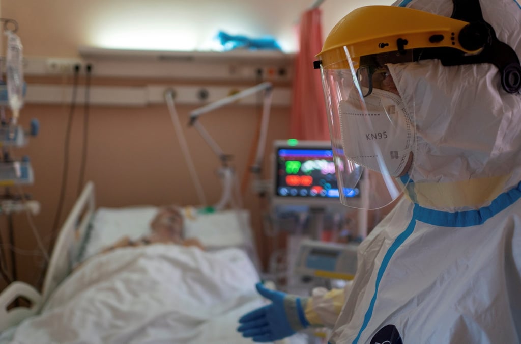 A health worker treats a Covid-19 patient at a city hospital in Gliwice, Poland. Photo: Agencja Wyborcza.pl via Reuters