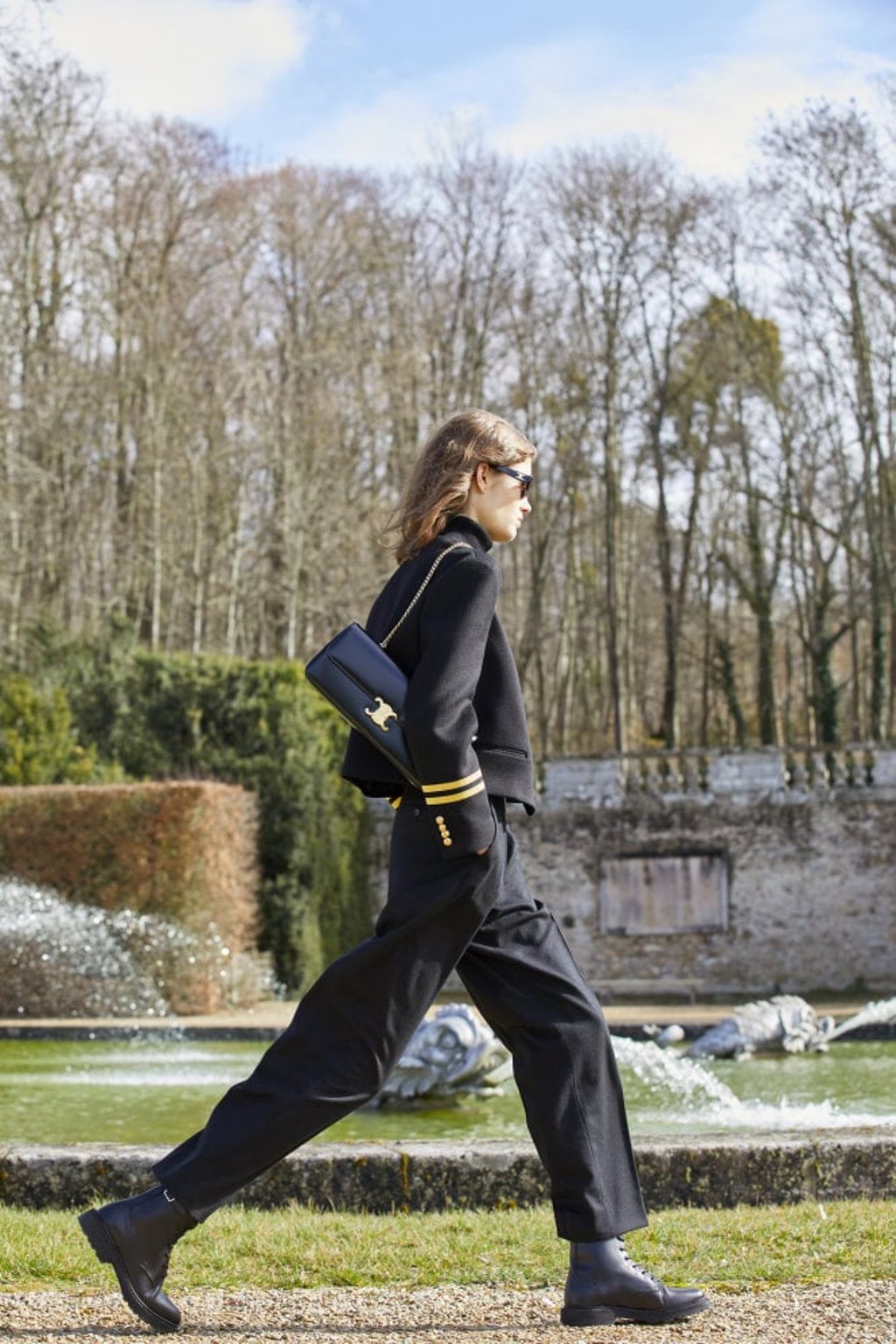 Stepping out, winter 2021 style, a new Celine Triomphe bag in black slung confidently from the shoulder.